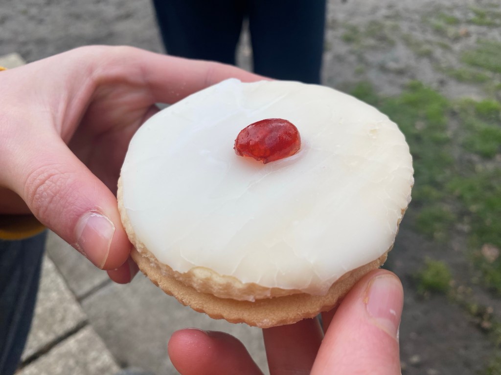 hands holding a gluten free empire biscuit