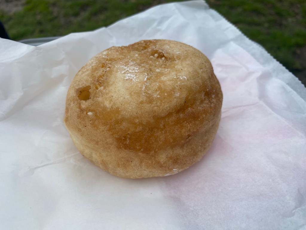 A gluten free doughnut on a paper bag