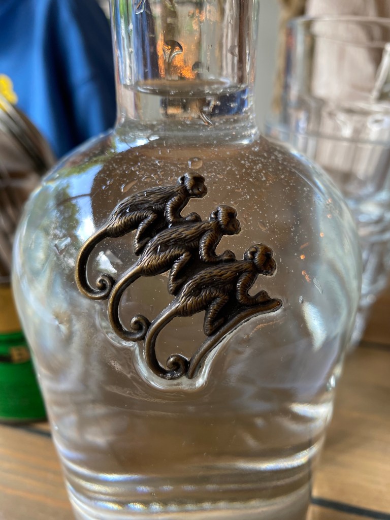 Close up of water bottle with three monkeys on