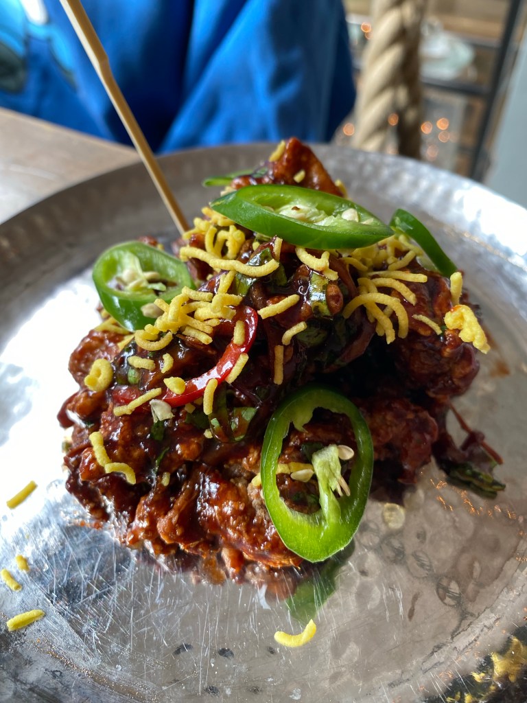 Sticky chicken on a metal plate