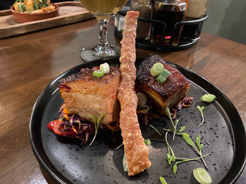 a plate with some belly pork and crackling