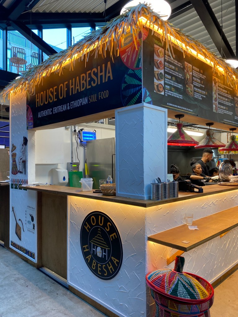 An indoor food stall selling Eritrean and Ethiopian food