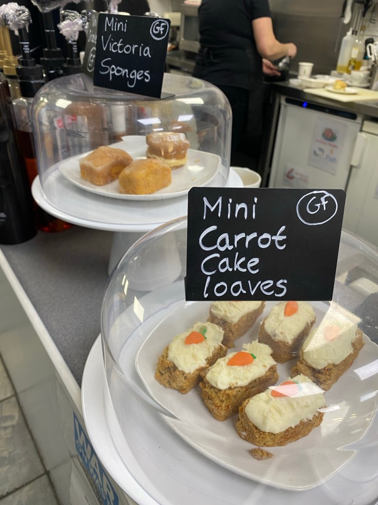 Lovely, gluten free mini Victoria sponges and mini carrot cakes protected by glass cloches