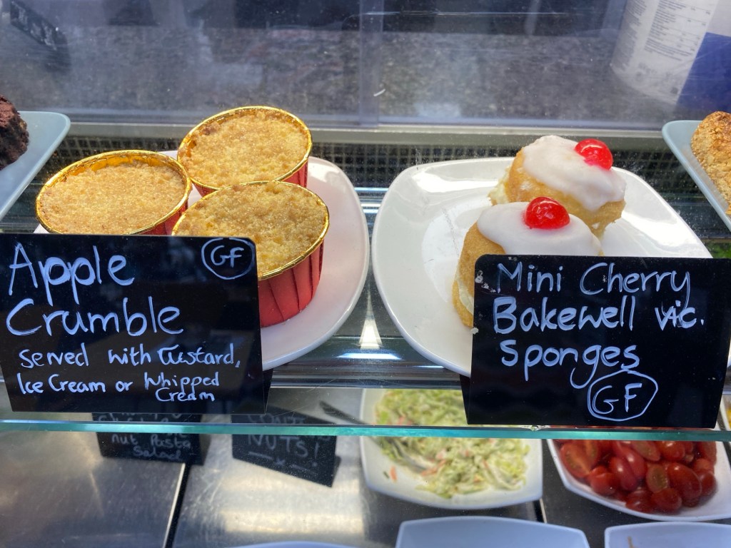 Apple tarts and Bakewell sponge cakes in a glass counter